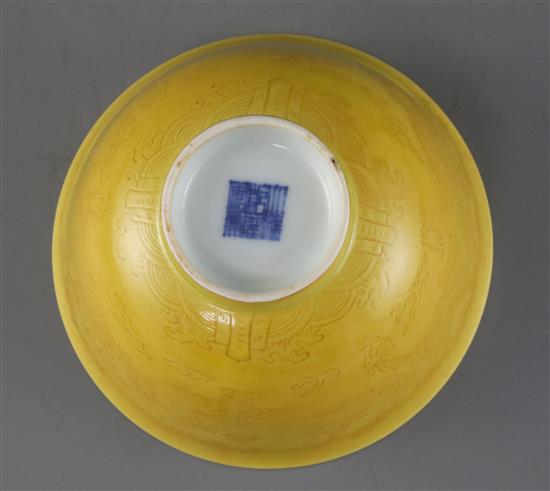 A Chinese yellow glazed sgraffito dragon bowl, Qianlong seal mark and of the period (1736-95), Diam.13.3cm, restored